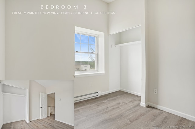 10 Stirling Ct, Middletown, CT 06457 - empty room featuring a baseboard heating unit, wood finished floors, and baseboards