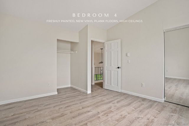 10 Stirling Ct, Middletown, CT 06457 - unfurnished bedroom with wood finished floors, baseboards, a closet, and high vaulted ceiling