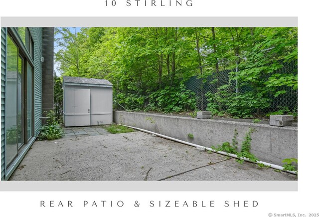 10 Stirling Ct, Middletown, CT 06457 - view of patio / terrace featuring a storage unit, an outdoor structure, and fence