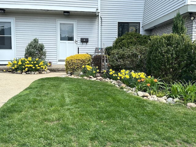 entrance to property with a yard