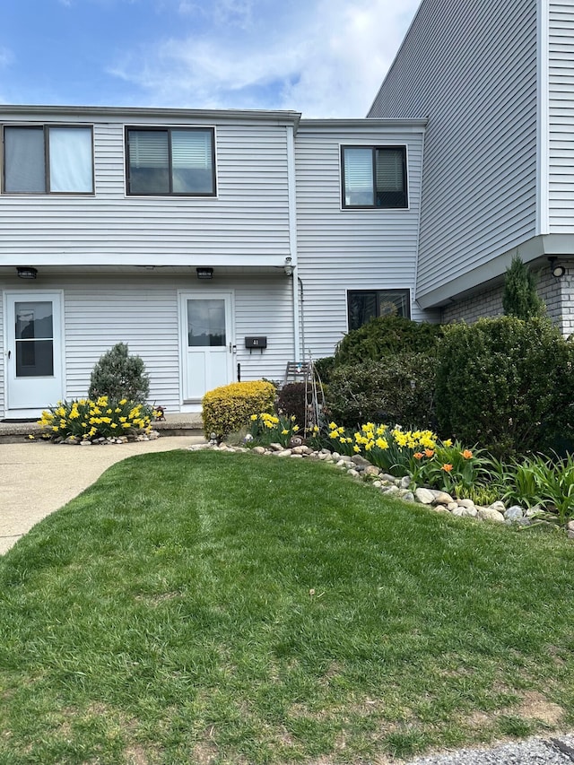 rear view of property with a yard