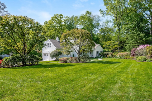 view of grassy yard featuring an attached garage