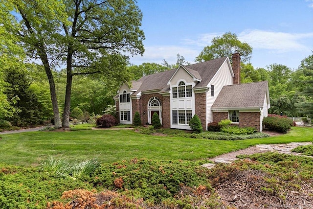 48 Cherry Gate Ln, Trumbull, CT 06611 - view of front of house featuring a chimney, a front yard, brick siding, and roof with shingles