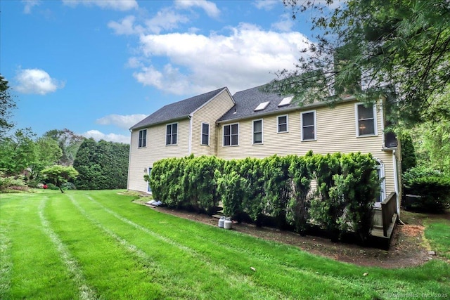 back of property featuring a lawn