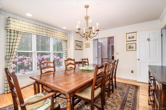 dining room with a chandelier, light wood finished floors, crown molding, baseboards, and recessed lighting