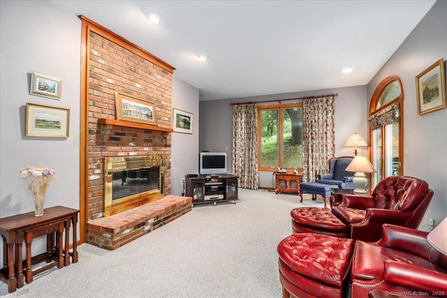 carpeted living area featuring a fireplace and recessed lighting
