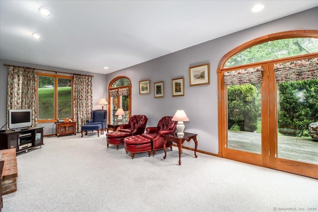 carpeted living room with plenty of natural light, baseboards, and recessed lighting