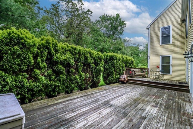 wooden deck with view of scattered trees