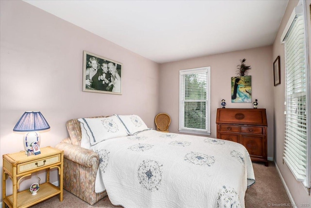 carpeted bedroom with baseboards