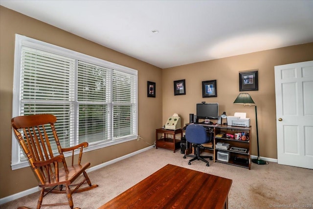 carpeted home office featuring baseboards
