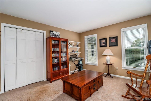 office featuring light carpet and baseboards