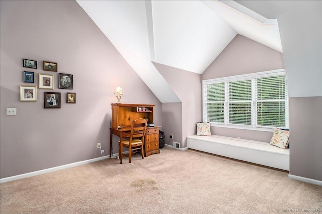 carpeted office with lofted ceiling and baseboards