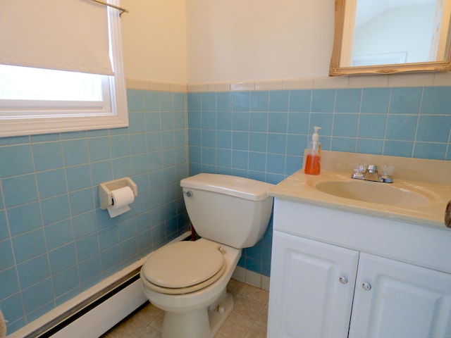 992 Ridge Rd, Wethersfield, CT 06109 - half bathroom featuring baseboard heating, toilet, vanity, tile patterned flooring, and tile walls