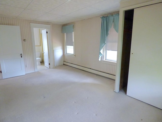 992 Ridge Rd, Wethersfield, CT 06109 - unfurnished bedroom featuring a baseboard heating unit, carpet floors, ensuite bathroom, and a drop ceiling