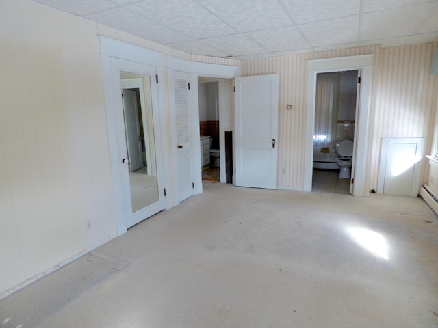 992 Ridge Rd, Wethersfield, CT 06109 - empty room featuring baseboard heating, a drop ceiling, and wood walls