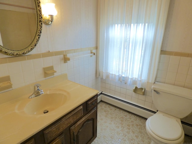 992 Ridge Rd, Wethersfield, CT 06109 - bathroom featuring tile walls, a baseboard heating unit, vanity, and toilet