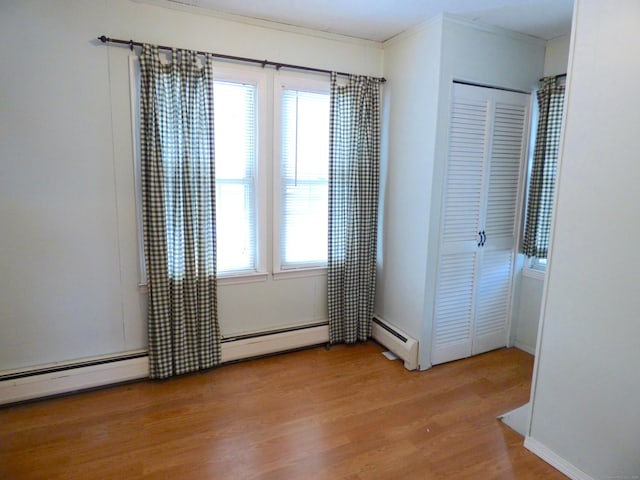 992 Ridge Rd, Wethersfield, CT 06109 - unfurnished bedroom with wood finished floors, a closet, and crown molding