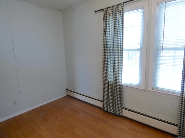 992 Ridge Rd, Wethersfield, CT 06109 - empty room with baseboard heating, wood finished floors, and baseboards