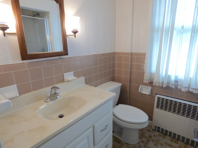992 Ridge Rd, Wethersfield, CT 06109 - full bathroom featuring radiator heating unit, tile walls, a stall shower, vanity, and toilet