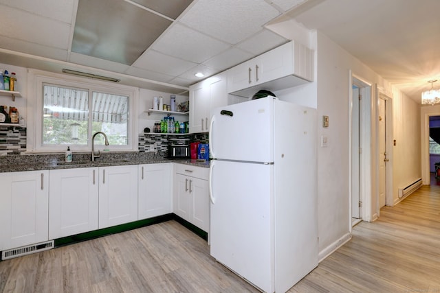53 Harwinton Ave Apt 1, Torrington, CT 06790 - kitchen featuring freestanding refrigerator, open shelves, a baseboard radiator, dark stone countertops, and light wood-type flooring