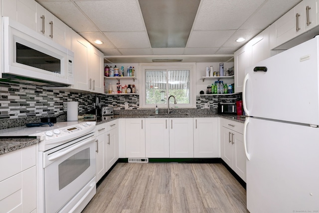53 Harwinton Ave Apt 1, Torrington, CT 06790 - kitchen featuring white appliances, open shelves, a sink, a paneled ceiling, and dark stone countertops