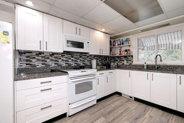 53 Harwinton Ave Apt 1, Torrington, CT 06790 - kitchen with white appliances, a sink, dark stone countertops, light wood-type flooring, and tasteful backsplash
