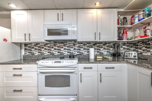 53 Harwinton Ave Apt 1, Torrington, CT 06790 - kitchen with white appliances, white cabinets, decorative backsplash, dark stone countertops, and open shelves
