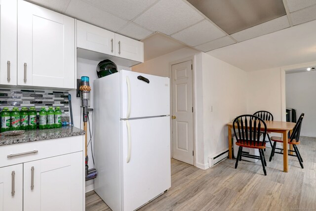 53 Harwinton Ave Apt 1, Torrington, CT 06790 - kitchen with freestanding refrigerator, light wood-type flooring, tasteful backsplash, white cabinets, and a drop ceiling