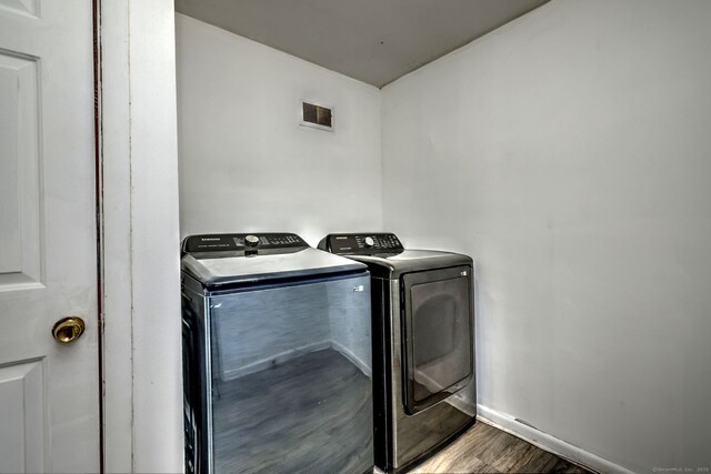 53 Harwinton Ave Apt 1, Torrington, CT 06790 - laundry room featuring washing machine and clothes dryer, wood finished floors, and baseboards