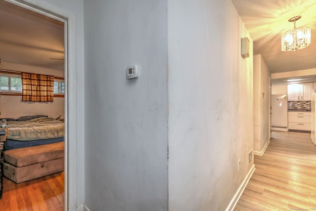 53 Harwinton Ave Apt 1, Torrington, CT 06790 - hall featuring light wood finished floors, a chandelier, baseboards, and baseboard heating