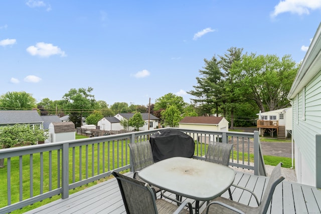 315 Prospect St, Wethersfield, CT 06109 - wooden terrace featuring a storage unit, an outbuilding, outdoor dining space, a lawn, and a residential view