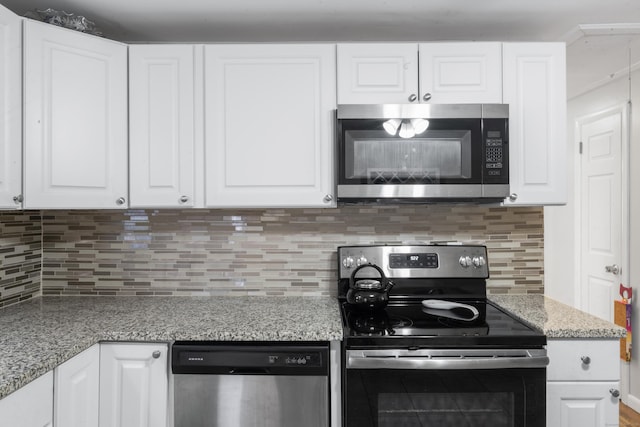 315 Prospect St, Wethersfield, CT 06109 - kitchen with stainless steel appliances, white cabinetry, and decorative backsplash