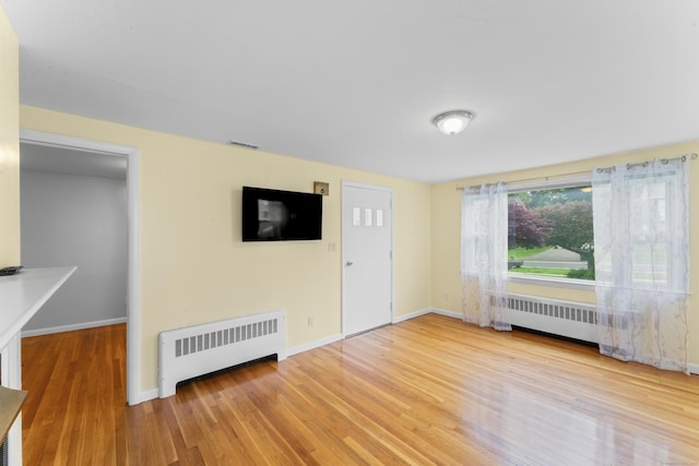 315 Prospect St, Wethersfield, CT 06109 - spare room featuring radiator, wood finished floors, and baseboards