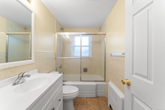 315 Prospect St, Wethersfield, CT 06109 - full bath with tile walls, radiator, vanity, tile patterned floors, and a wainscoted wall