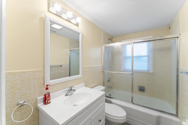 315 Prospect St, Wethersfield, CT 06109 - full bathroom featuring tile walls, enclosed tub / shower combo, vanity, wainscoting, and toilet