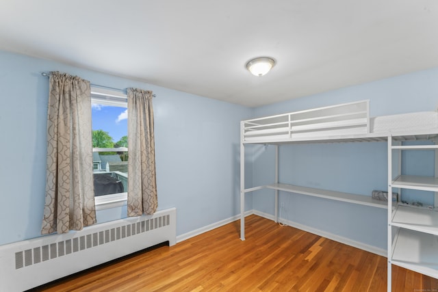 315 Prospect St, Wethersfield, CT 06109 - unfurnished bedroom featuring radiator heating unit, wood finished floors, and baseboards