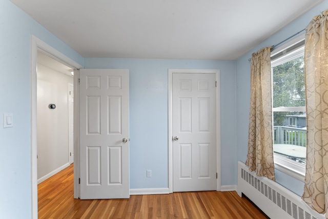 315 Prospect St, Wethersfield, CT 06109 - unfurnished bedroom with radiator heating unit, wood finished floors, and baseboards