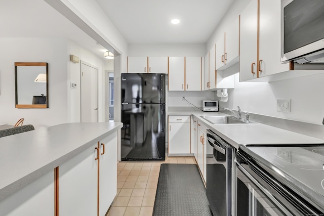 42 Temple Ct Unit 42, New Haven, CT 06511 - kitchen featuring freestanding refrigerator, range with electric stovetop, a sink, stainless steel microwave, and dishwashing machine