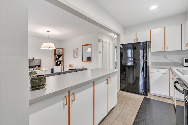42 Temple Ct Unit 42, New Haven, CT 06511 - kitchen with black appliances, white cabinetry, light tile patterned flooring, light countertops, and recessed lighting