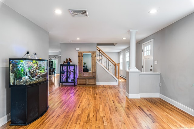 57 Harvard Ct, Middletown, CT 06457 - entryway featuring ornate columns, light wood-style floors, baseboards, recessed lighting, and stairway