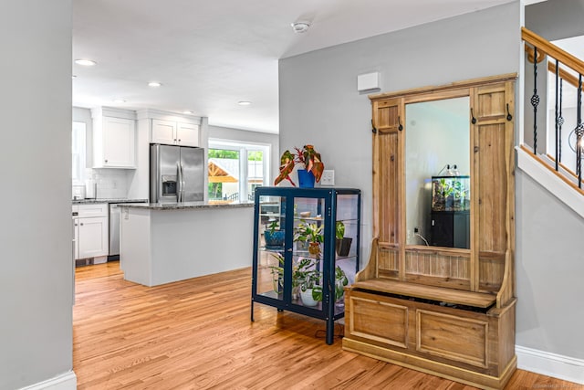57 Harvard Ct, Middletown, CT 06457 - kitchen with appliances with stainless steel finishes, white cabinetry, light wood-type flooring, stone countertops, and backsplash