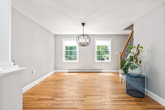 57 Harvard Ct, Middletown, CT 06457 - unfurnished dining area featuring baseboard heating, light wood-style flooring, a chandelier, and baseboards