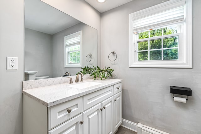 57 Harvard Ct, Middletown, CT 06457 - bathroom featuring healthy amount of natural light, vanity, baseboard heating, and baseboards