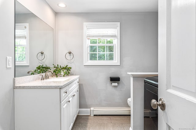 57 Harvard Ct, Middletown, CT 06457 - bathroom featuring baseboard heating, vanity, toilet, and baseboards