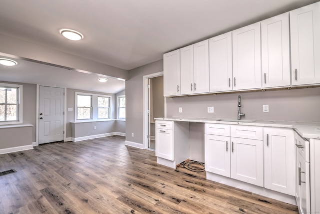 167 Gilbert St, West Haven, CT 06516 - kitchen with a sink, light countertops, white cabinetry, and light wood-style flooring