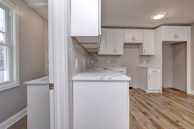 167 Gilbert St, West Haven, CT 06516 - kitchen with a sink, white cabinets, light stone counters, light wood finished floors, and healthy amount of natural light