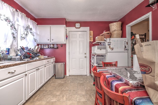 167 Gilbert St, West Haven, CT 06516 - kitchen with white cabinets, white appliances, and a textured ceiling