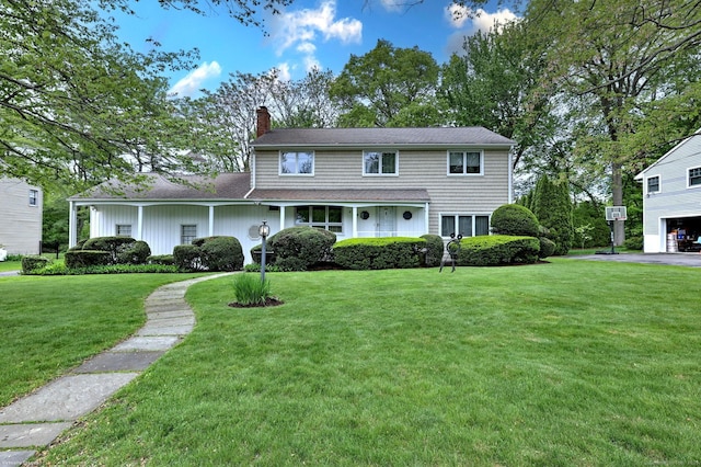 145 Casmir Dr, Fairfield, CT 06825 - view of front of house featuring a chimney and a front lawn