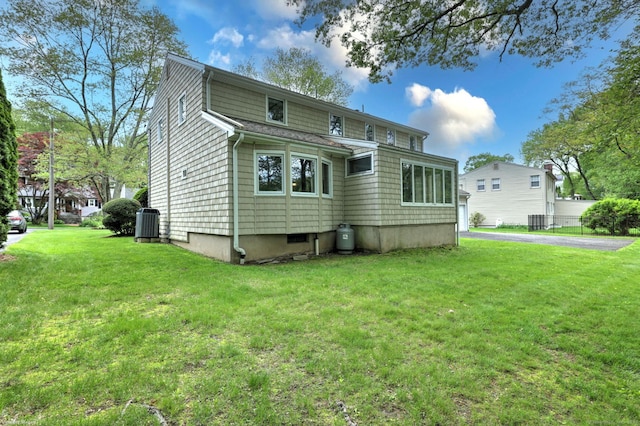 145 Casmir Dr, Fairfield, CT 06825 - back of house featuring central AC and a yard