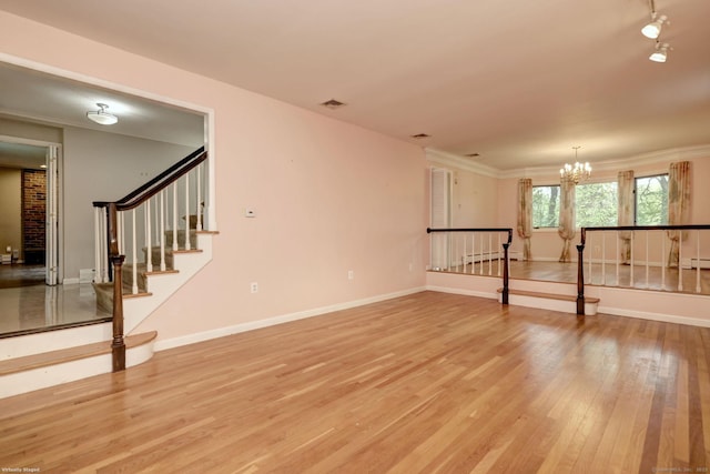 145 Casmir Dr, Fairfield, CT 06825 - unfurnished room featuring light wood-type flooring, a chandelier, baseboards, baseboard heating, and a baseboard heating unit